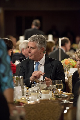 Anthony Bourdain at a dining table